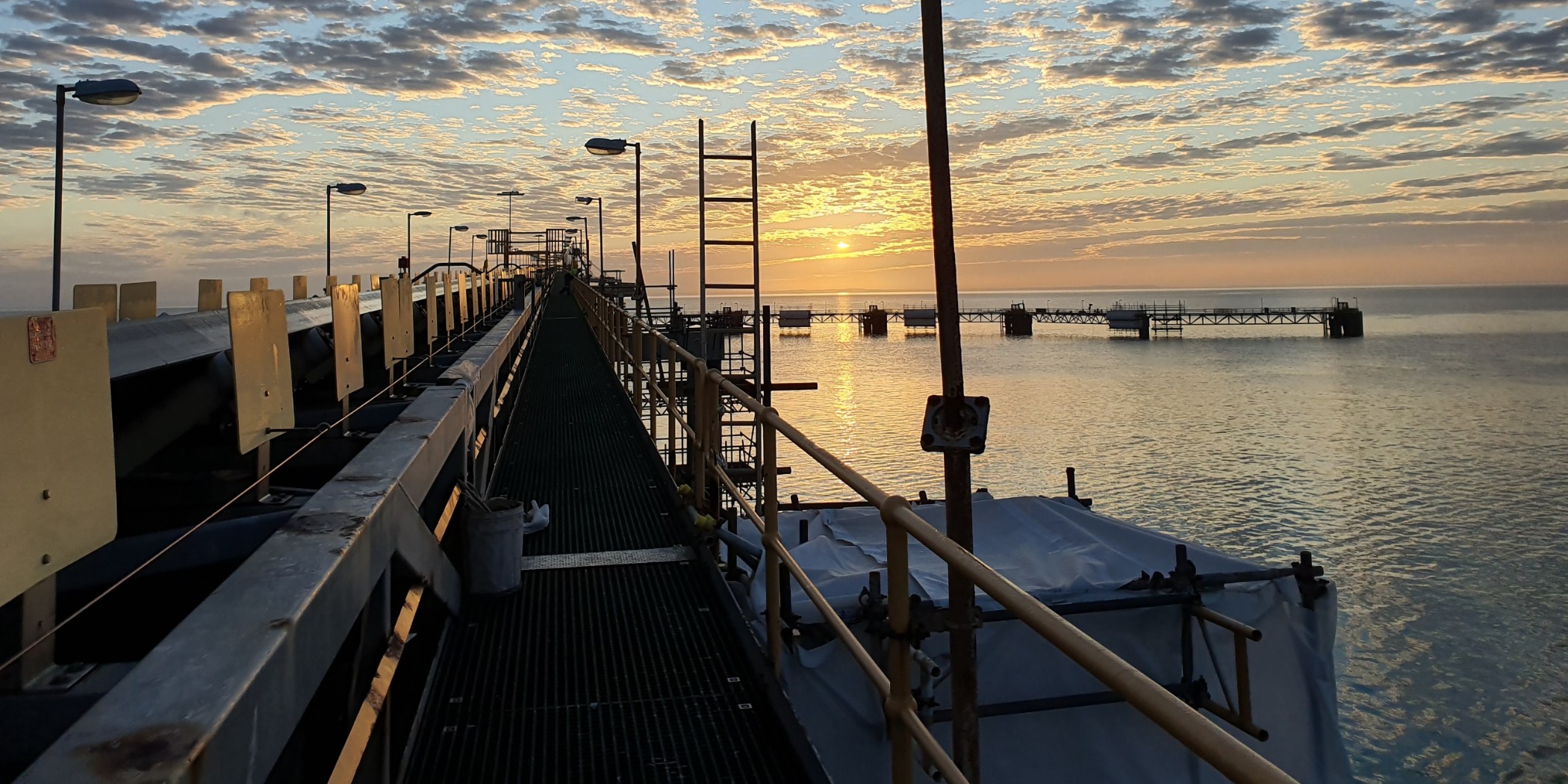 Scaffolding over water at sunset